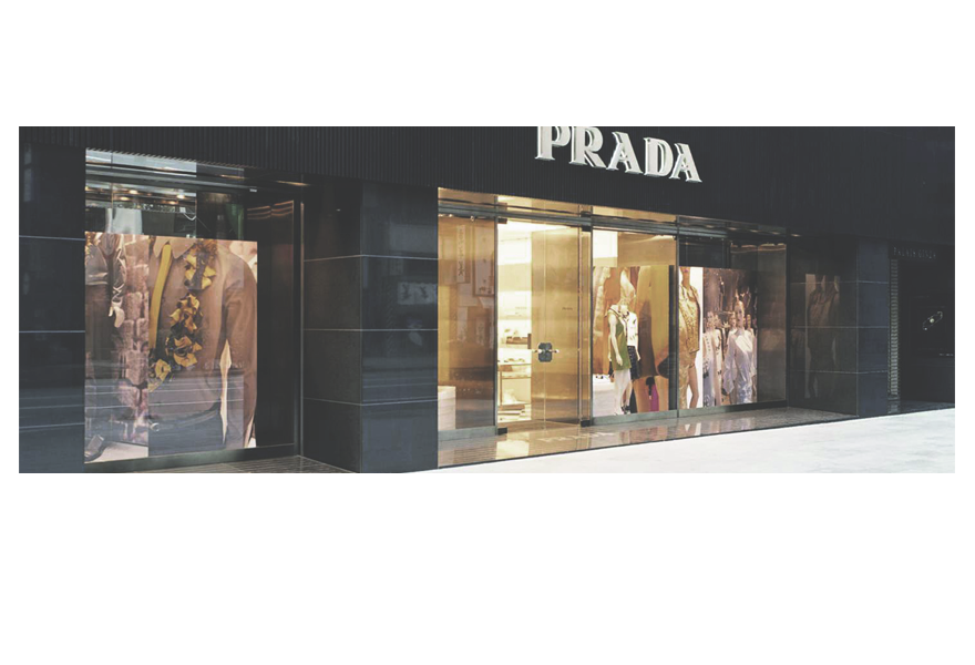 The Prada label was begun in 1913 by Mario Prada when he began selling shoes, leather handbags and trunks. He opened two boutiques in Milan after experience in Europe and U.S.A.The classic Prada suitcase was made of heavy walrus skin but as plane travel made heavy suitcases impractical, the company started to make lighter bags and high quality items made of crystals, tortoise shell and wood. They also sold garments of waterproof fabrics to the U.S. However the company had gone into decline in the 1970's. 